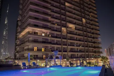 a building with a swimming pool in front of a building at Luxury Studio Near Burj Khalifa in Dubai