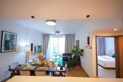 a living room with a table and a dining room at Modern 1BR 4 guest apartment World Trade Center in Dubai