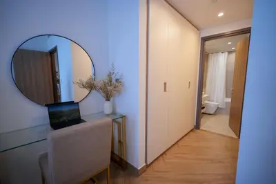 a bathroom with a mirror and a desk with a laptop at Modern 1BR 4 guest apartment World Trade Center in Dubai