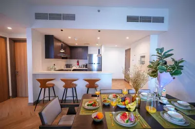 a dining room and kitchen with a table with food on it at Modern 1BR 4 guest apartment World Trade Center in Dubai