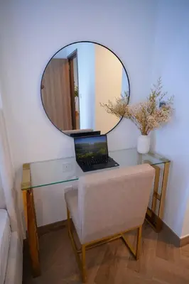 a desk with a laptop and a mirror on it at Modern 1BR 4 guest apartment World Trade Center in Dubai