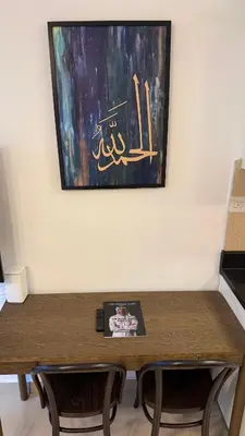 a table with two chairs and a painting on the wall at Modern Studio in Damac Park Tower - Near Dubai Mall & Metro in Dubai