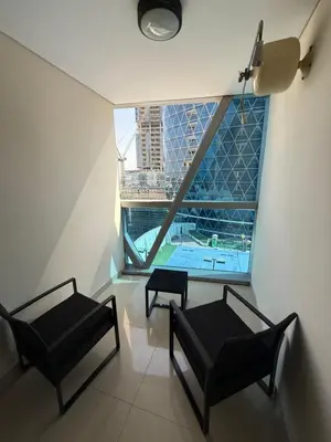 a room with two chairs and a table and a window at Modern Studio in Damac Park Tower - Near Dubai Mall & Metro in Dubai