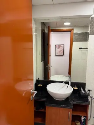 a bathroom with a sink and a mirror at Modern Studio in Damac Park Tower - Near Dubai Mall & Metro in Dubai