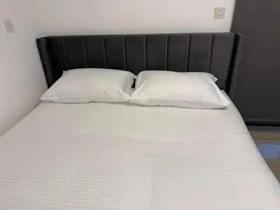 a bed with two white pillows on top of it at Modern Studio in Damac Park Tower - Near Dubai Mall & Metro in Dubai