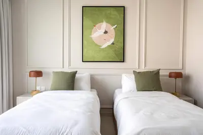 two beds sitting next to each other in a room at Luxury 3BR & Maid - Canal View - Near Downtown in Dubai