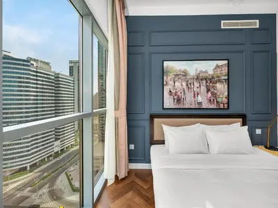 a bedroom with a bed and a large window at Burj Khalifa View 2 Bedroom Apartment in Dubai