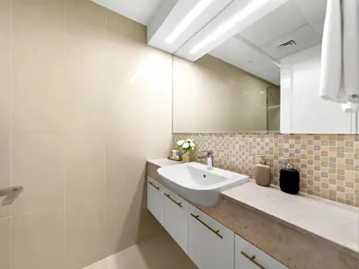 a bathroom with a sink and a mirror at Burj Khalifa View 2 Bedroom Apartment in Dubai