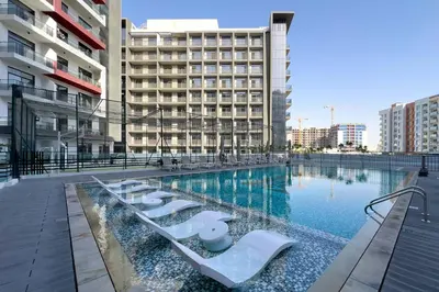 a large swimming pool in a city with buildings at Luxury Retreat in Arjan with Refined Living in Dubai