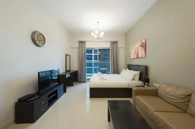 a hotel room with a bed and a couch at Elite Studio Retreat in Business Bay District in Dubai