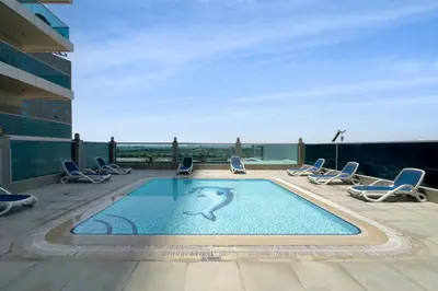 a swimming pool on the roof of a building at Elite Studio Retreat in Business Bay District in Dubai