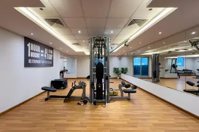 a gym with treadmills and exercise equipment in a room at Elite Studio Retreat in Business Bay District in Dubai