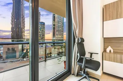 a room with a chair and a window with a view at FIRST CLASS 2BR Sky Views City Vibes in Dubai