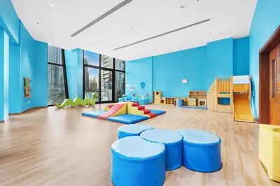 a childrens play room with blue walls and blue stools at FIRST CLASS 2BR Sky Views City Vibes in Dubai