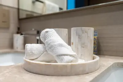 a pair of rolled up towels in a bathroom at Grande, Luxurious 2 BR, Burj Khalifa & Fountain view in Dubai