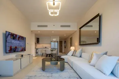 a living room with a white couch and a table at Maison Privee - Urban & Elegant Stay Just Steps from Burj Khalifa in Dubai