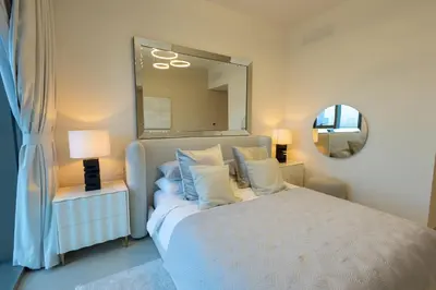 a bedroom with a bed with a large mirror at Maison Privee - Urban & Elegant Stay Just Steps from Burj Khalifa in Dubai