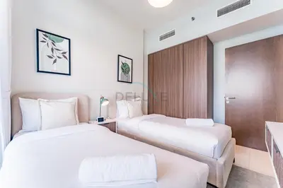two beds in a hotel room with white sheets at High-Rise 2BR with Dubai Water Canal View, Quick Access to Downtown, Vera Tower, Business Bay by Deluxe Holiday Homes in Dubai
