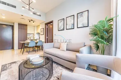 a living room with a couch and a table at High-Rise 2BR with Dubai Water Canal View, Quick Access to Downtown, Vera Tower, Business Bay by Deluxe Holiday Homes in Dubai