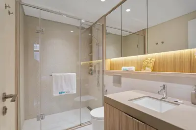 a bathroom with a shower and a sink and a toilet at Art-Inspired 1 Bedroom in Wilton Terraces in Dubai