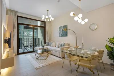 a living room with a table and a couch at Art-Inspired 1 Bedroom in Wilton Terraces in Dubai