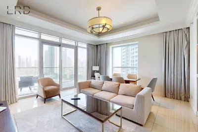 a living room with a couch and chairs and windows at Iconic Burj View in Downtown Dubai in Dubai