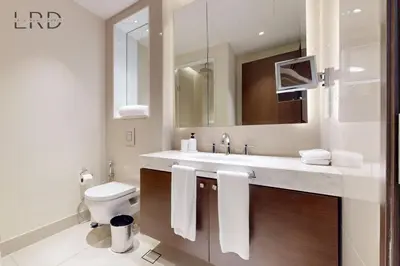 a bathroom with a sink and a toilet and a mirror at Iconic Burj View in Downtown Dubai in Dubai