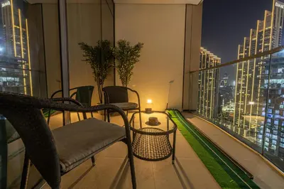 a balcony with a view of a city at night at Exclusive Burj Khalifa View, Steps From Dubai Mall, Infinity Pool in Dubai