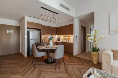 a kitchen and living room with a table and chairs at Exclusive Burj Khalifa View, Steps From Dubai Mall, Infinity Pool in Dubai