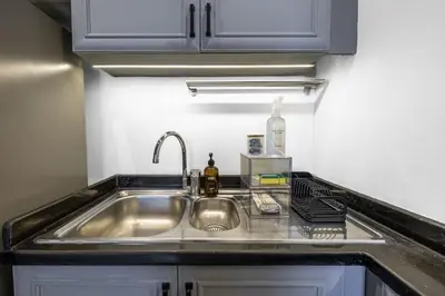 a kitchen counter with a sink in a kitchen at Stylish 1BR in Marina - 5 Min Walk to Beach in Dubai