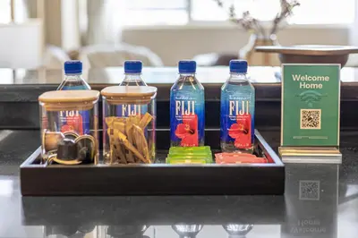 a tray with three bottles of water on a table at Stylish 1BR in Marina - 5 Min Walk to Beach in Dubai