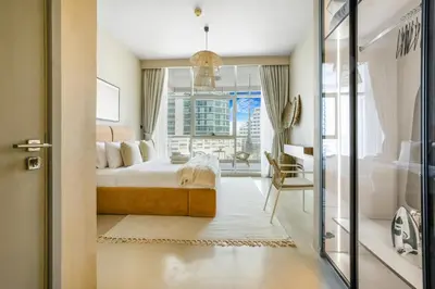 a bedroom with a bed and a large window at Stylish 1BR in Marina - 5 Min Walk to Beach in Dubai