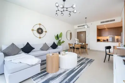 a living room with a couch and a table at Vogue Marina 52-42 Towers near Ain Dubai and JBR Beach, Two Bedroom Apartment with Balcony Canal and Skyline views, Access to all Amenities in Dubai