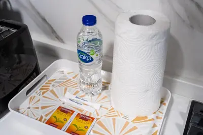 a roll of toilet paper and a bottle of water at Luxurious JVC Studio Near Circle Mall & Parks in Dubai