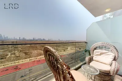 a balcony with two chairs and a view of the city at Chic and Aesthetic Studio! Move-In Ready in Dubai