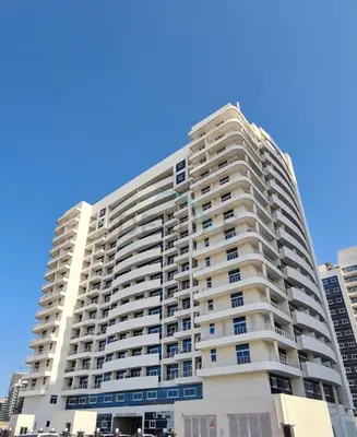 a tall white apartment building in a city at Studio with Balcony Facing the Community, Located Near Golf Clubs and Cricket Stadium, Royale Residence 1 , Dubai Sports City by Deluxe Holiday Homes in Dubai