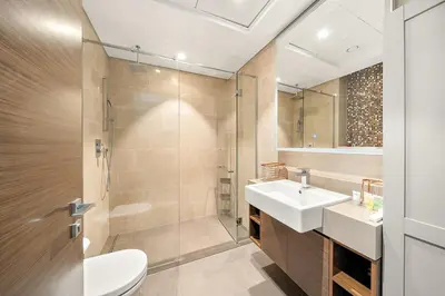a bathroom with a toilet and a sink and a shower at Luxurious 2BR Apartment in Sobha Hartland Greens in Dubai