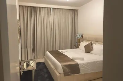 a hotel room with a bed and a window at Best Emaar Beachfront view one bedroom in Dubai