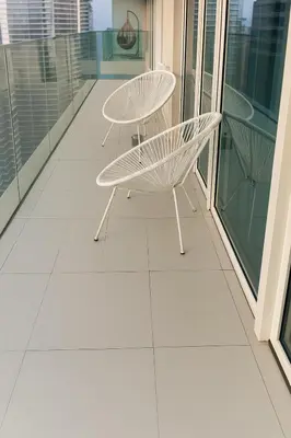 a balcony with two chairs and a table on it at Best Emaar Beachfront view one bedroom in Dubai