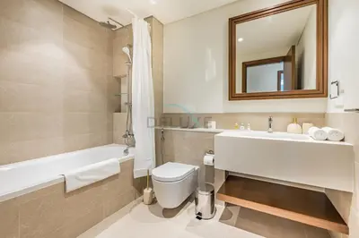 a bathroom with a sink and a toilet and a tub at 1BR With Private Beach Access, Near Dubai Marina Walk, Next to Dubai Harbour Marina & Yacht Club, Palace Beach Residence, Dubai Marina by Deluxe Holiday Homes in Dubai