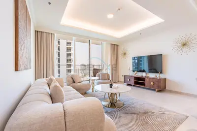 a living room with a couch and a table at 1BR With Private Beach Access, Near Dubai Marina Walk, Next to Dubai Harbour Marina & Yacht Club, Palace Beach Residence, Dubai Marina by Deluxe Holiday Homes in Dubai