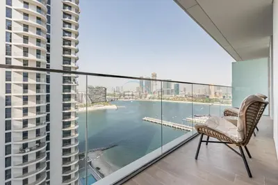 a balcony with a view of a body of water at 1BR With Private Beach Access, Near Dubai Marina Walk, Next to Dubai Harbour Marina & Yacht Club, Palace Beach Residence, Dubai Marina by Deluxe Holiday Homes in Dubai