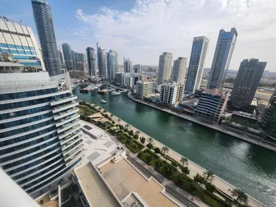 a view of a river in a city with tall buildings at The Dorra Bay Offers Stunning 2bedroom Duplex JBR Sea View Marina Canal view in Dubai
