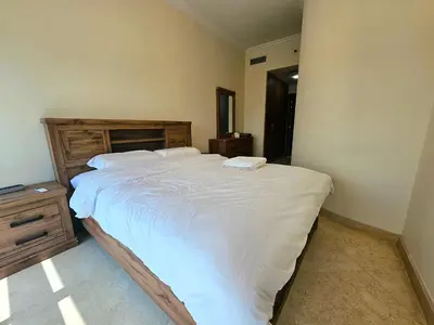 a bedroom with a large bed with white sheets at The Dorra Bay Offers Stunning 2bedroom Duplex JBR Sea View Marina Canal view in Dubai