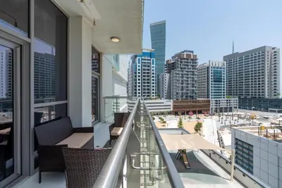 a balcony with chairs and a view of a city at Ahlan HH - Stylish Suite Heart of Business Bay Avanti Tower in Dubai