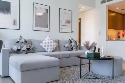 a living room with a couch and a table at Vogue Marina 52-42 Towers near Ain Dubai and JBR Beach, Two Bedroom Apartment with Balcony Canal and Skyline views, Access to all Amenities in Dubai