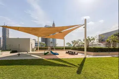 awning in a park with a playground and a swing at Vogue Marina 52-42 Towers near Ain Dubai and JBR Beach, Two Bedroom Apartment with Balcony Canal and Skyline views, Access to all Amenities in Dubai