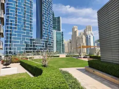 a park in a large city with tall buildings at Vogue Marina 52-42 Towers near Ain Dubai and JBR Beach, Two Bedroom Apartment with Balcony Canal and Skyline views, Access to all Amenities in Dubai