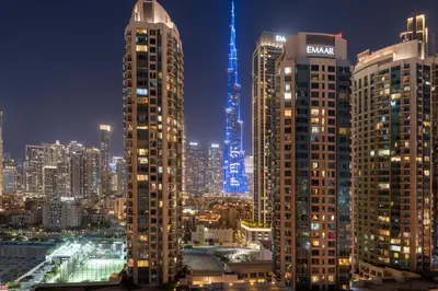a view of a city at night with tall buildings at Luxury Burj & Fountain View Retreat in Dubai