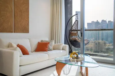 a living room with a couch and a glass table at Luxury Burj & Fountain View Retreat in Dubai